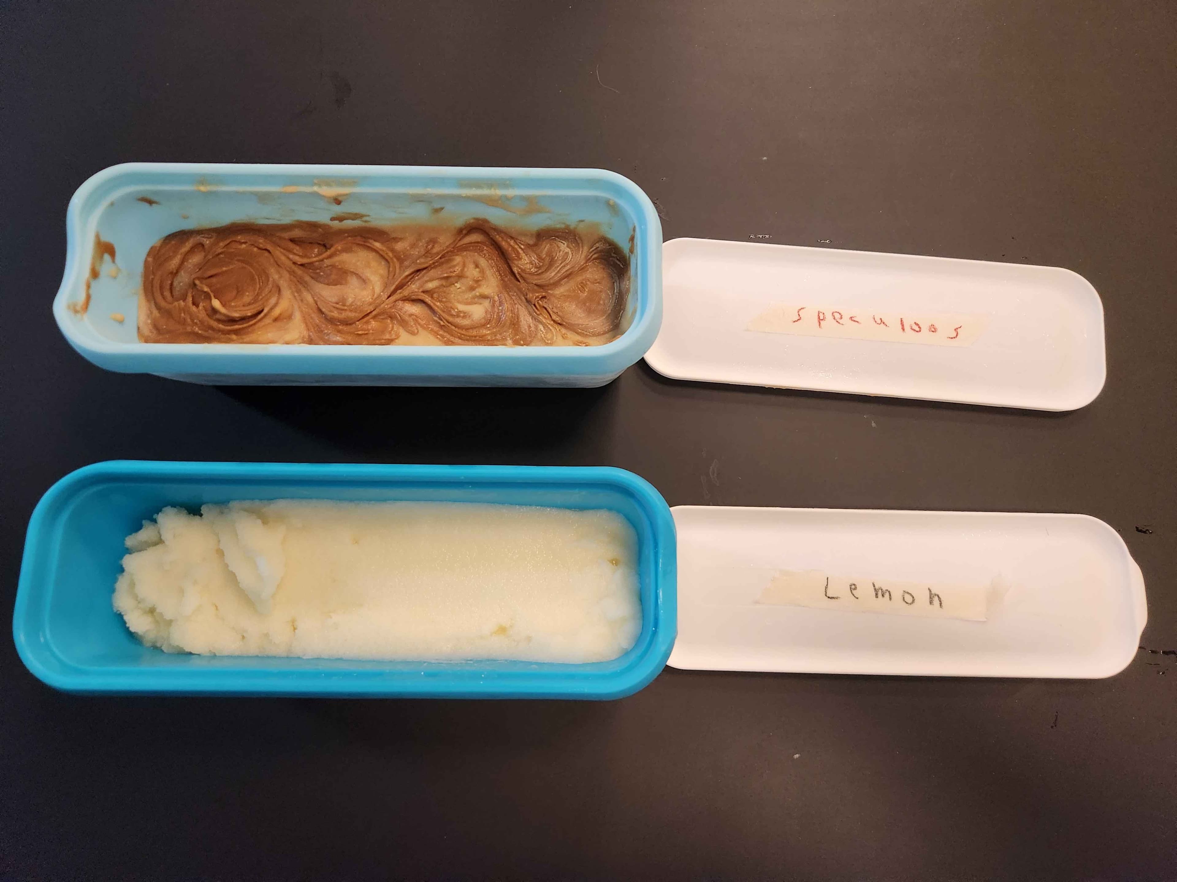 Two tubs of homemade ice cream, lemon and speculoos flavors